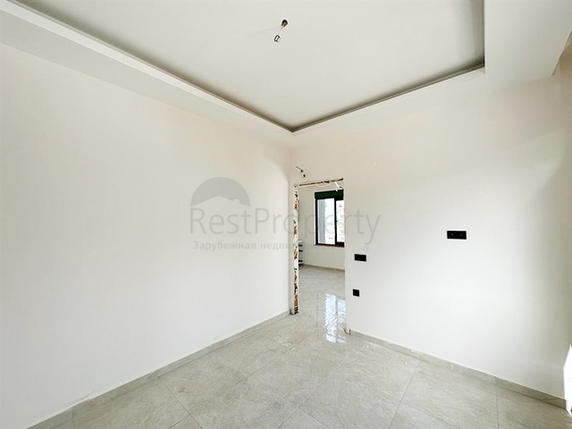 1+1 apartment in a building under construction in Mahmutlar district