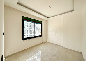 1+1 apartment in a building under construction in Mahmutlar district