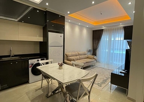 One-bedroom furnished apartment in a new complex in Mahmutlar