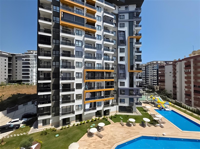 Rent a cozy 1+1 apartment with rich infrastructure in the heart of Mahmutlar